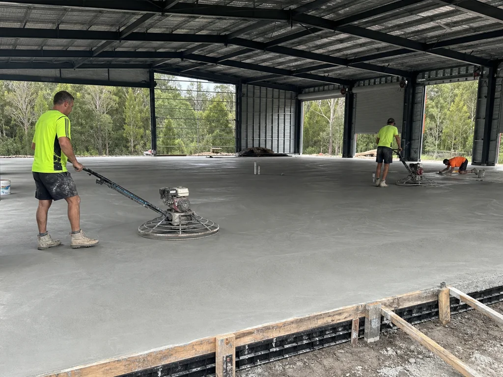 Concreters power trowelling a commercial concrete floor