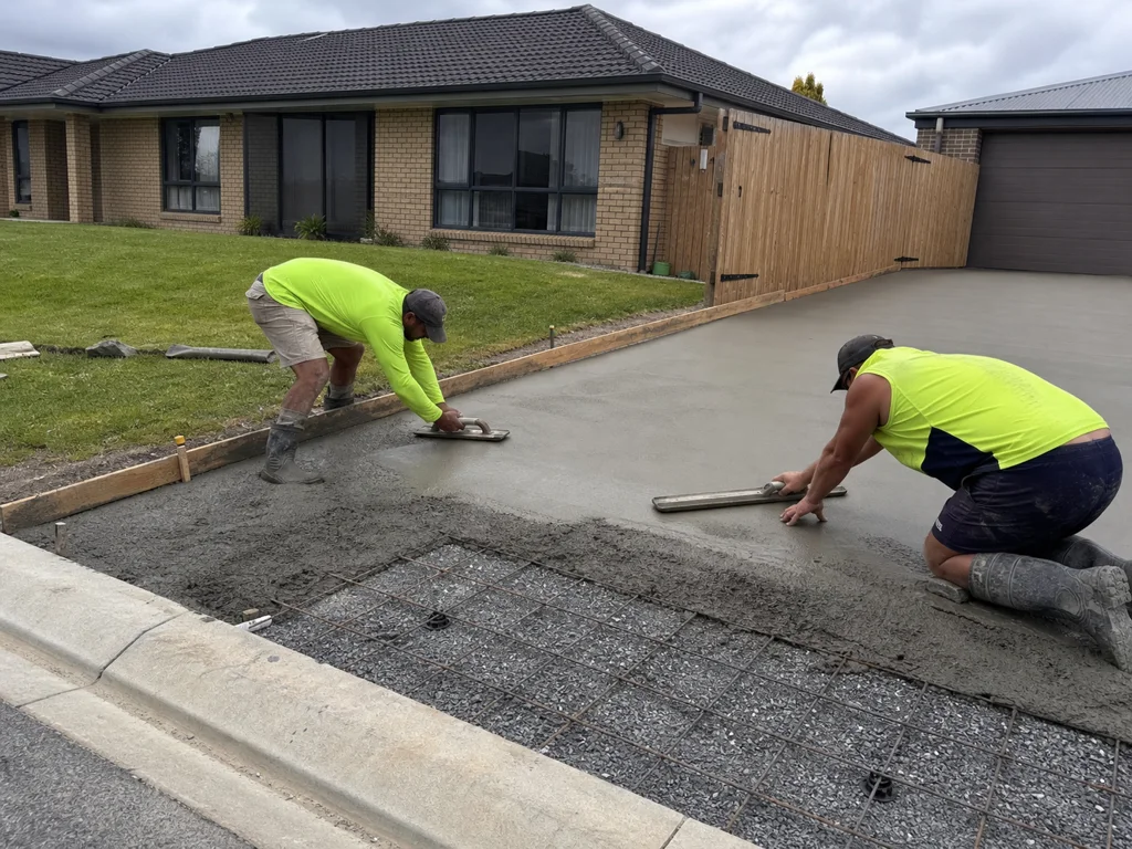 Concreters finishing a residential driveway pour