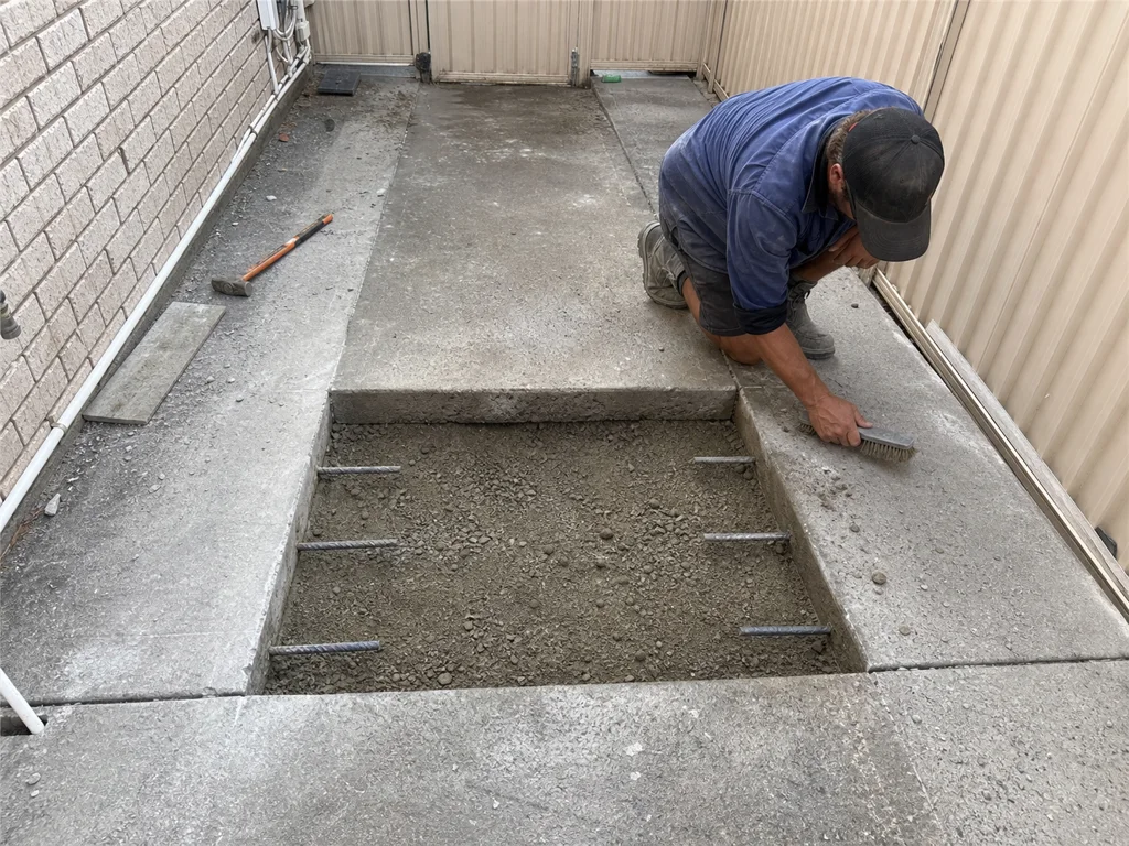 Damaged concrete path section prepared for replacement